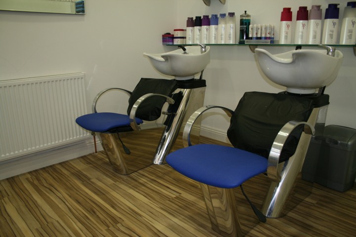 Two backwash basins with royal blue chairs