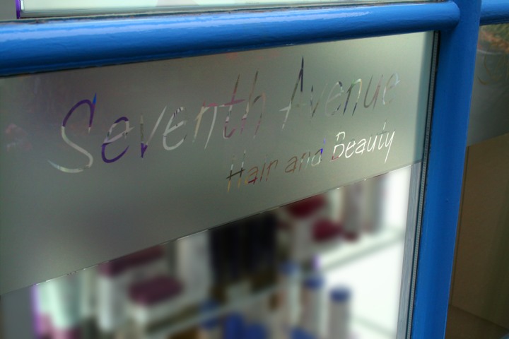 The Seventh Avenue name etched into a mirror with a royal blue frame